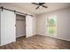 Bedroom featuring hardwood floors, neutral paint, window and sliding closet door at 599 Honey Creek Rd, Conyers, GA 30094