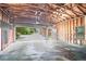 A large garage with an open door showing unfinished walls, concrete floor, and view of exterior grounds at 599 Honey Creek Rd, Conyers, GA 30094
