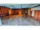 Spacious garage with wood walls, concrete floor, shelving, and a small window at 599 Honey Creek Rd, Conyers, GA 30094