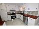 Stylish kitchen featuring butcher block countertops, subway tile backsplash, and white cabinets at 599 Honey Creek Rd, Conyers, GA 30094