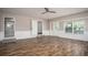 Spacious living room with hardwood floors, ceiling fan, and natural light from two windows at 599 Honey Creek Rd, Conyers, GA 30094