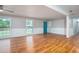 Bright living room featuring hardwood floors, large windows, and fresh paint at 599 Honey Creek Rd, Conyers, GA 30094