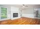 Cozy living room featuring hardwood floors, white brick fireplace and bright windows at 599 Honey Creek Rd, Conyers, GA 30094