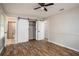 Bright main bedroom with hardwood floors, ceiling fan, closet, and ensuite bathroom at 599 Honey Creek Rd, Conyers, GA 30094