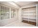 Bright pantry featuring open shelving, tiled floors, and a window for natural light at 599 Honey Creek Rd, Conyers, GA 30094