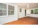 Screened-in porch featuring a ceiling fan, white painted brick, and painted wood floor at 599 Honey Creek Rd, Conyers, GA 30094