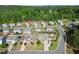 An aerial view of a well-maintained neighborhood with lush green trees and manicured lawns on a sunny day at 6235 Crescent Landing Dr, Cumming, GA 30028