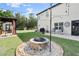 Spacious backyard with a fire pit, patio area, and lush landscaping at 6235 Crescent Landing Dr, Cumming, GA 30028