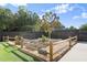Inviting backyard featuring a raised garden with a decorative wind spinner and charming wooden fence at 6235 Crescent Landing Dr, Cumming, GA 30028