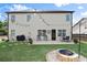 Large backyard featuring a fire pit, patio with dining set, and a well-manicured lawn, great for gatherings at 6235 Crescent Landing Dr, Cumming, GA 30028
