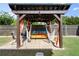 Cozy backyard lounge area featuring a covered pergola with hammocks, a daybed, and comfortable seating at 6235 Crescent Landing Dr, Cumming, GA 30028