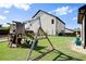 Spacious backyard featuring a wooden swing set with slides and swings, perfect for outdoor fun at 6235 Crescent Landing Dr, Cumming, GA 30028