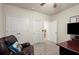 Bedroom featuring a neutral color palette, plush chair, and an entertainment center at 6235 Crescent Landing Dr, Cumming, GA 30028