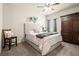 Bedroom with carpet flooring, ceiling fan, window with blinds and an armoire for storage at 6235 Crescent Landing Dr, Cumming, GA 30028