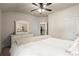 Bedroom with a white dresser, ceiling fan, and soft, white carpet and bedspread at 6235 Crescent Landing Dr, Cumming, GA 30028