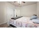 Bedroom with bed, fan, patterned bedding, and large, double door closet at 6235 Crescent Landing Dr, Cumming, GA 30028
