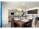 Open dining area features a pendant light and flows into the kitchen and living room at 6235 Crescent Landing Dr, Cumming, GA 30028