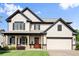 Charming two-story home featuring a welcoming front porch and a well-maintained lawn at 6235 Crescent Landing Dr, Cumming, GA 30028