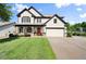 Beautiful two-story home with a well-kept lawn, charming porch, and attached garage at 6235 Crescent Landing Dr, Cumming, GA 30028