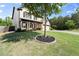 Charming two-story home with a manicured lawn and mature tree in the front yard at 6235 Crescent Landing Dr, Cumming, GA 30028