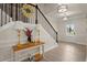 Entryway with staircase, decorative lamps, console table, and 'Hello' sign at 6235 Crescent Landing Dr, Cumming, GA 30028