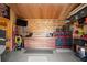 Garage with custom woodworking, tool storage, and a wall-mounted television for entertainment at 6235 Crescent Landing Dr, Cumming, GA 30028