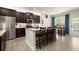 Modern kitchen featuring stainless steel appliances, granite countertops, and a breakfast bar at 6235 Crescent Landing Dr, Cumming, GA 30028