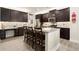 Modern kitchen featuring stainless steel appliances, granite countertops, and a breakfast bar at 6235 Crescent Landing Dr, Cumming, GA 30028