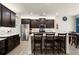 Modern kitchen featuring stainless steel appliances, granite countertops, and a breakfast bar at 6235 Crescent Landing Dr, Cumming, GA 30028