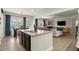 Spacious kitchen open to the living room with island seating and stainless steel appliances at 6235 Crescent Landing Dr, Cumming, GA 30028