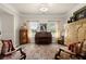 Sitting room featuring vintage furniture, a piano, natural light, and elegant decor at 6235 Crescent Landing Dr, Cumming, GA 30028