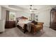 Serene main bedroom boasting a tray ceiling and elegant furnishings at 6235 Crescent Landing Dr, Cumming, GA 30028
