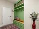 Well-organized mudroom area with storage bench, hooks, and drawers at 6235 Crescent Landing Dr, Cumming, GA 30028