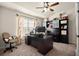 A well-lit office featuring a ceiling fan, a large desk, and built-in shelves, offering a functional workspace at 6235 Crescent Landing Dr, Cumming, GA 30028