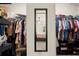 Spacious walk-in closet with ample shelving, hanging rods, and full-length mirror at 6235 Crescent Landing Dr, Cumming, GA 30028