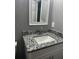 Bathroom vanity featuring granite counters, gray walls, stainless steel faucet, and white cabinetry at 324 Cynthia Ct, Jonesboro, GA 30238