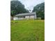 Charming one-story home featuring a white porch and stone accents in a large front yard at 324 Cynthia Ct, Jonesboro, GA 30238
