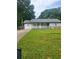 Charming one-story home featuring a white porch, stone accents, and a lush green lawn at 324 Cynthia Ct, Jonesboro, GA 30238