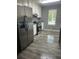 Modern kitchen with stainless steel appliances, gray walls, updated lighting, and wood-look flooring at 324 Cynthia Ct, Jonesboro, GA 30238