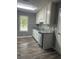 Well-lit kitchen featuring white cabinetry, granite countertops, stainless steel appliances and updated floors at 324 Cynthia Ct, Jonesboro, GA 30238