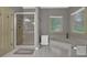 Bathroom featuring a glass enclosed shower, soaking tub, and window with natural light at 4373 Mikandy Nw Dr, Kennesaw, GA 30144