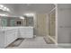 Bathroom showcasing a double vanity, a large framed mirror, and a glass-enclosed shower at 4373 Mikandy Nw Dr, Kennesaw, GA 30144