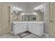 Bathroom with a double vanity with white cabinets, large mirrors, and tiled floor at 4373 Mikandy Nw Dr, Kennesaw, GA 30144