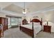 Spacious bedroom with a tray ceiling, ceiling fan, large windows and hardwood furniture at 4373 Mikandy Nw Dr, Kennesaw, GA 30144