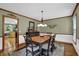 Inviting dining room with wood floors, view to kitchen, and modern light fixture at 4373 Mikandy Nw Dr, Kennesaw, GA 30144