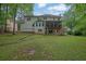 Back exterior view of home featuring a screened porch, large windows, and a well-manicured lawn at 4373 Mikandy Nw Dr, Kennesaw, GA 30144