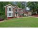 Lovely brick home with a manicured lawn, flower beds, and an attached two-car garage at 4373 Mikandy Nw Dr, Kennesaw, GA 30144