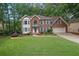 Charming two-story brick home with a well-manicured lawn and attached two-car garage at 4373 Mikandy Nw Dr, Kennesaw, GA 30144