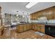 Kitchen with wood cabinets, stainless sink and appliances, view to eat in area at 4373 Mikandy Nw Dr, Kennesaw, GA 30144