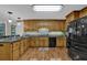 Kitchen features wood cabinets, stainless sink and appliances, and modern flooring at 4373 Mikandy Nw Dr, Kennesaw, GA 30144